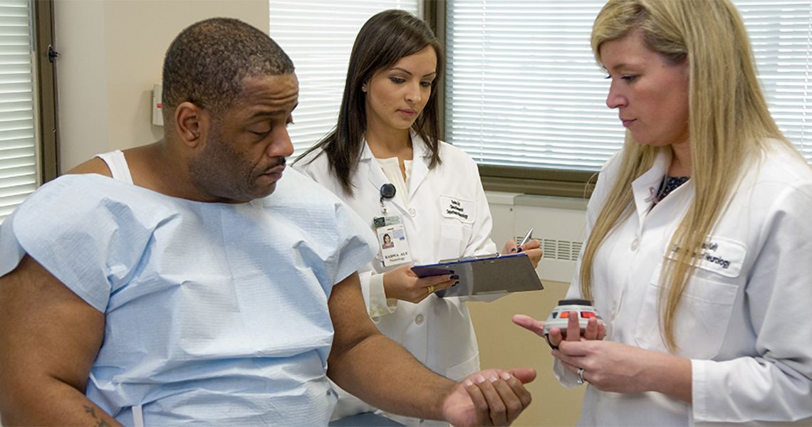 Patient being tested by two doctors/researchers